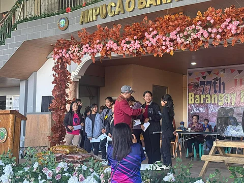 Students from Barangay Ampucao receive reward money for their academic excellence courtesy of Philex Mining Corp.