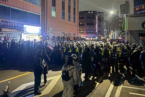 Police stand guard on a street near the Seoul Western District Court in Seoul, early on January 19, 2025, after hundreds of pro-Yoon protesters smashed windows and broke down doors to enter the court following the extension of the detention of impeached South Korea President Yoon Suk Yeol. A South Korean court extended the detention of impeached President Yoon Suk Yeol on January 19 over concerns he could destroy evidence linked to his martial law declaration, enraging his supporters who attacked the court building.
Jin-kyu Kang / AFP