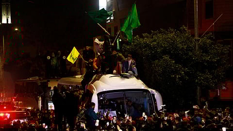 Palestinians brandish Hamas and Hezbollah flags as they welcome freed Prisoners Beitunia, in the occupied West Bank, on January 20, 2025.