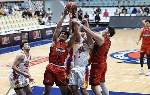 Cliff Jopia of Blackwater (No. 8) fights for the rebound during their PBA Commissioner’s Cup game against Phoenix Super LPG at the Ynares Center last night. The Bossing prevailed, 100-92.