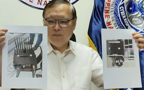 Department of Information and Communications Technology (DICT) Secretary Ivan John Uy on Wednesday (Jan. 22, 2025) shows reporters photos of the International Mobile Subscriber Identity (IMSI) catchers seized from a Malaysian nationals.