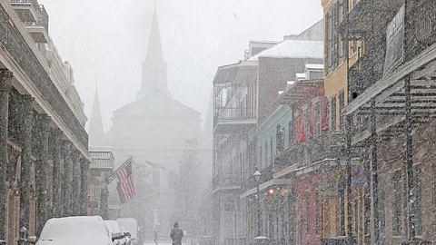 A cathedral in the French Quarter of New Orleans is barely visible in heavy snow that has blanketed the southern US city in a rare winter storm