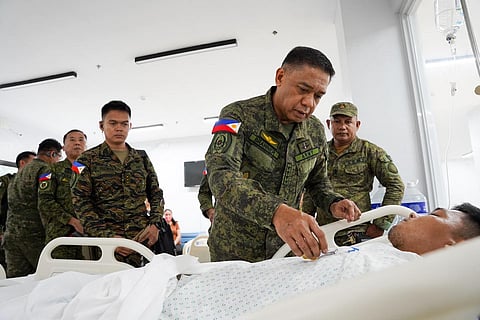 AFP Chief of Staff General Romeo S. Brawner Jr. awards the Wounded Personnel Medal to a soldier of the 32nd Infantry Battalion on Thursday.