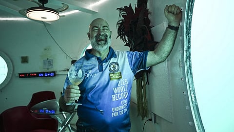 German aerospace engineer Rudiger Koch, 59, celebrates after breaking the Guinness world record for living in the ocean at a depth of eleven meters off the coast of Puerto Lindo, Panama, on 25 January 2025.