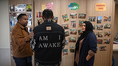 'John' (C), who fled persecution in an East African nation, had been set for resettlement in the United States until President Donald Trump halted refugee arrivals