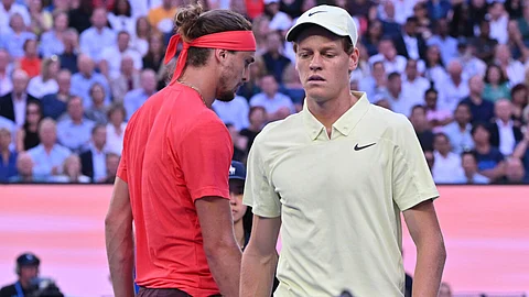 Italy's Jannik Sinner and Germany's Alexander Zverev walk between games during their men's singles final