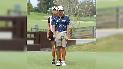 Lloyd Jefferson Go gets help from his sister and caddie, Lois Kaye Go, in reading the green during the first round of The Country Club (TCC) Invitational 2025 yesterday at the TCC course in Santa Rosa, Laguna.