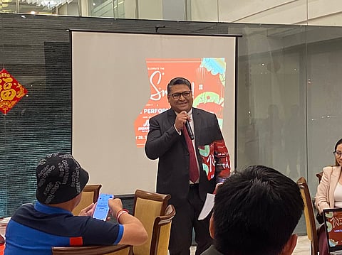 Charley Magabo, Hotel101 general manager, announces Hotel101’s expansion plans during a Chinese New Year celebration at Jinjiang Inn.