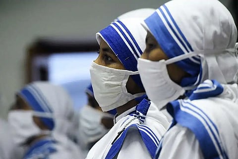 Missionaries of Charity nuns pray at the tomb of Mother Teresa at a service to commemorate her 23rd death anniversary at the congregation's house in Kolkata on Sept. 5, 2020.
