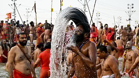 Swarming throngs of devotees bathed in rivers at the world's biggest religious gathering in India on Thursday