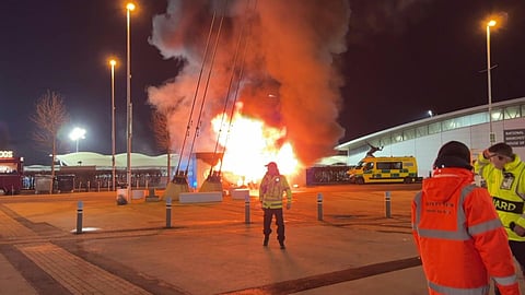 flames engulf a merchandise stall outside of the Etihad Stadium in Manchester, north west England, ahead of the UEFA Champions League football match between Manchester City and Club Brugge
