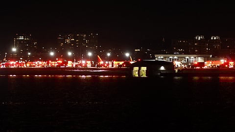 Lights from emergency vehicles are seen at Reagan National Airport in Washington, DC, after an air crash near the Potomac River on 29 January 2025.