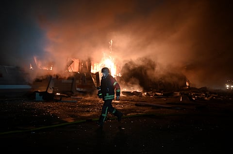 A rescuer of the State Emergency Service works to extinguish a fire in a building after a drone strike in Kharkiv, on January 28, 2025, amid the Russian invasion in Ukraine.