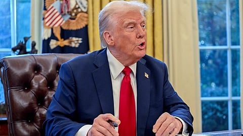 US President Donald Trump speaks to the press after signing an executive order in the Oval Office of the White House on 30 January 2025 in Washington, DC.