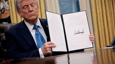 U.S. President Donald Trump hold up an executive order, "Unleashing prosperity through deregulation," that he signed in the Oval Office on 31 January 2025 in Washington, DC. Trump spoke to reporters about tariffs against China, Canada and Mexico and how the newly confirmed Interior Secretary Doug Burghum will coordinate with the Energy Department and the Environmental Protection Agency.