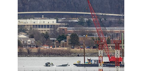 A crane moves in to place on the Potomac River for recovery efforts on 02 February 2025 in Arlington, Virginia. An American Airlines flight from Wichita, Kansas collided midair with a military Black Hawk helicopter while on approach to Ronald Reagan Washington National Airport on 29 January 2025 outside of Washington, DC. According to reports, there were no survivors among the 67 people onboard both aircraft.