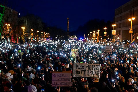 Protesters use their cell phone lights during a demonstration under the motto 'Loud against Nazis' in front of the headquarters of the Christian Democratic Union (CDU) in Berlin on 2 February 2025. Berlin on 2 February braced for scores of demonstrators to converge on the German capital to protest against the country's conservatives' norm-shattering overtures toward the far right.