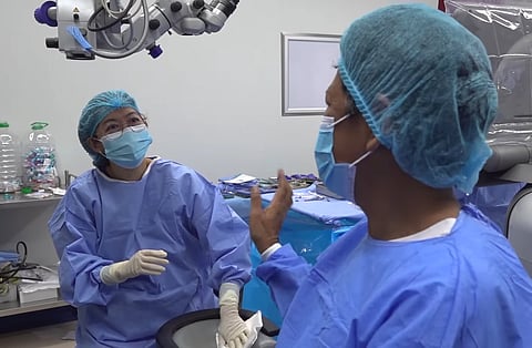 NELLY Fernandez (right) of Binmaley, Pangasinan happily leaves the operating room at the TCEC after a successful cataract removal operation at the Tzu Chi Eye Center in Manila last year. Fernandez also received livelihood assistance from Tzu Chi Medical Foundation Philippines.