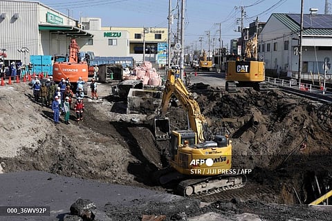 LOOK: Excavators and rescue personnel working to construct a slope for rescue operations are seen at the site where a truck on January 28 plunged into a sinkhole, trapping the vehicle's driver, in Yashio, Saitama Prefecture on February 1, 2025. Japanese rescuers completed building a slope on February 1 to reach a truck driver stuck in a sinkhole, officials said, four days after his vehicle was swallowed by the cavity now 40 meters wide.