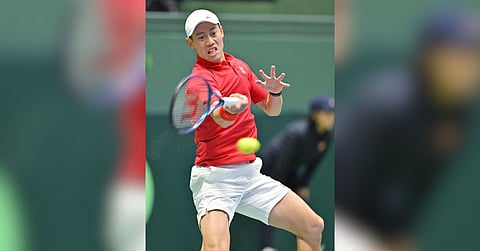 KEI Nishikori battles past Billy Harris of Great Britain 6-2, 6-3 in the deciding rubber to send Japan into the second qualifying round of the Davis Cup in September.