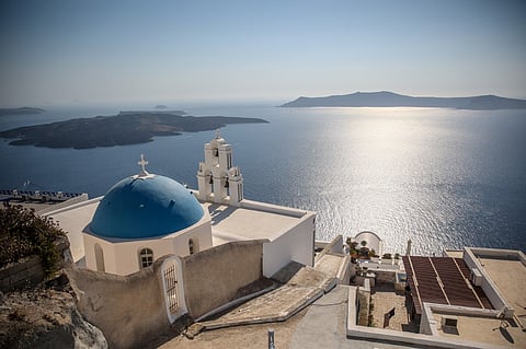 (FILES) This general view shows the Three Bells of Fira, the Catholic Church of the Dormition, in the village of Fira on the Greek island of Santorini on 19 July 2024. Schools on the Greek tourist island of Santorini will remain closed on February 3, 2025, after dozens of small earthquakes shook the region, civil protection authorities announced. Government officials, including Civil Protection Minister Vasilis Kikilias ordered the move on 2 February, after a series of tremors in the sea around Santorini and surrounding islands, the site of one of the largest volcanic eruptions in recorded history.