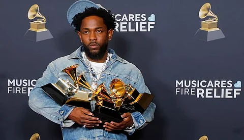 Kendrick Lamar poses with his grammy wins