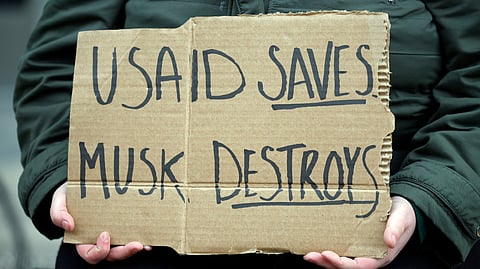 An employee of U.S. Agency for International Development (USAID) who wished to remain anonymous protests outside of the USAID headquarters on February 03, 2025 in Washington, DC. Elon Musk, tech billionaire and head of the Department of Government Efficiency (DOGE), saaid in a social media post that he and U.S. President Doanld Trump will shut down foreign assistance agency.