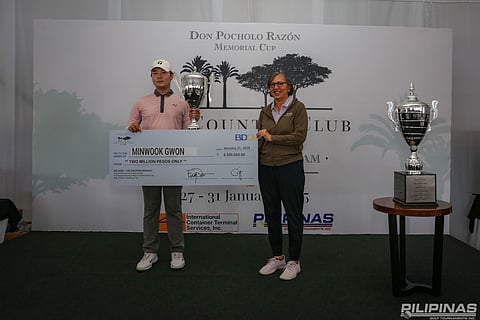 Korean Minwook Gwon holds The Country Club Invitational trophy and a replica of the P2 million check after winning the flagship event of the Philippine Golf Tour last weekend. Also shown is PGT and TCC general manager Colo Ventosa.