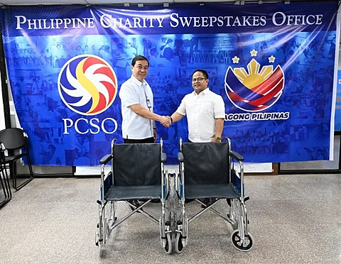 PCSO assistant general manager for Charity Sector Arnel N. Casas (left) turns over wheelchairs for persons with disabilities to Coop-NATCCO Partylist Representative Gerardo Esnares.