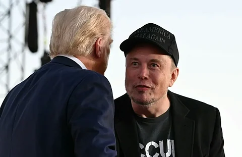 US government 'efficiency czar' Elon Musk (R), pictured with US President Donald Trump, has urged workers to take the resignation deal.