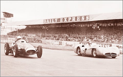 ARGENTINIAN Mercedes driver Juan Manuel Fangio races against British driver Stirling Moss at the Silverstone racetrack on 17 July 1954.