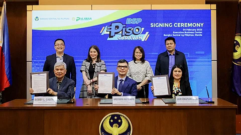 Palawan Group of Companies executives (seated, left to right) Bobby L. Castro, founder and chairman; Karlo Eugene Josef M. Castro, president and CEO; and Lilian Concepcion Castro-Selda, executive vice president and chief financial officer sign the contract to strengthen their support for the Bangko Sentral ng Pilipinas’ Piso Caravan. The contract signing was witnessed by top officials of the BSP including BSP Deputy Governor Bernadette Romulo-Puyat (standing, 2nd from left).