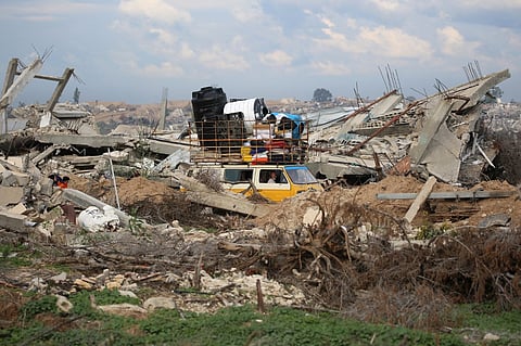 Displaced Palestinians cross the Netzarim corridor as they make their way to the northern parts of the Gaza Strip on February 9, 2025. The Israeli military completed its withdrawal from the Netzarim Corridor on a key highway in Gaza on 9 February 2025, as part of an ongoing ceasefire deal, a Hamas official told AFP.