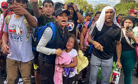 Migrants argue with Panamanian National Border Service members as they try to cross the border between Panama and Costa Rica while trying to return to Venezuela, at Paso Canoas between Panama and Costa Rica border on 11 February 2025.