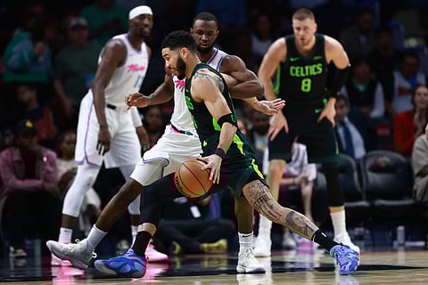 Jayson Tatum #0 of the Boston Celtics drives around Andrew Wiggins #22 of the Miami Heat during the second half at Kaseya Center on February 10, 2025 in Miami, Florida. NOTE TO USER: User expressly acknowledges and agrees that, by downloading and or using this Photograph, user is consenting to the terms and conditions of the Getty Images License Agreement.