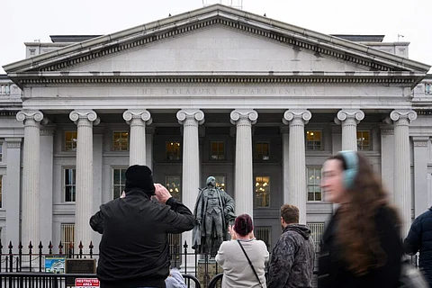 People take pictures of the US Treasury in Washington, DC, on February 6, 2025. Opponents to US President Donald Trump say he allowed Elon Musk — the world’s richest man and a major government contractor — to break the law by accessing US Treasury payment systems that send out trillions of dollars and hold a welter of sensitive personal data.