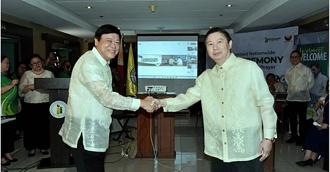 Philippine Health Insurance Corp. president and chief executive officer Edwin Mercado (left) and outgoing PCEO Emmanuel Ledesma Jr. shake hands during a turnover ceremony recently at the PhilHealth office in Pasig City. Mercado thanked Ledesma for his leadership and dedication in enhancing health benefit packages over the past two years.