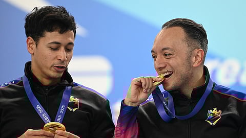 Two members of the triumphant men’s curling team — Alan Frei (right) and Enrico Pfister — and their teammates stand to receive cash rewards from the government for winning the gold medal in the Asian Winter Games in Harbin, China.