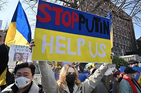 Ukrainians living in South Korea hold placards during a protest against Russia's invasion of Ukraine, near the Russian embassy in Seoul on 27 February 2022.