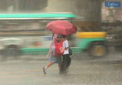 Pedestrians in EDSA use umbrellas amidst heavy rains on 17 February 2025