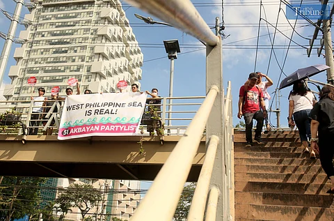 On Monday, 17 February 2025, Akbayan Party-list members carrying placards and waving banners at the footbridge along East Avenue in Quezon City urged motorists to honk their horns in support of Filipino fishers and frontline workers in the West Philippine Sea.