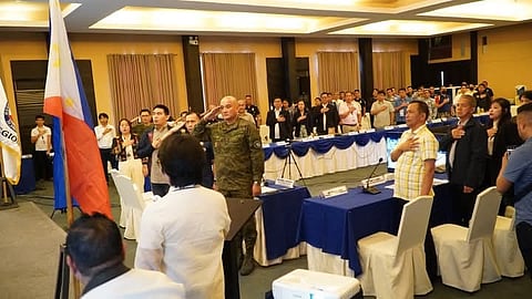 Brig. Gen. Michele Anayron Jr. salutes the Philippine flag during the Regional Peace Council meeting in Cagayan de Oro City.
