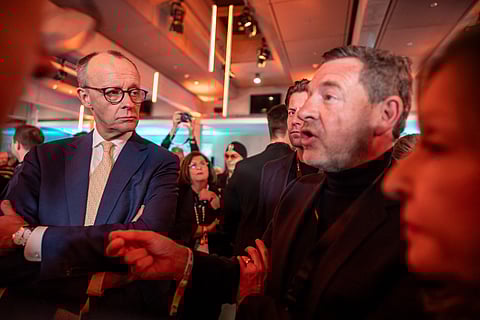 The leader of Germany’s Christian Democratic Union party Friedrich Merz (left) listens to German businessman and former journalist Kai Diekmann after a TV debate in Berlin, ahead of the parliamentary elections due to take place on 23 February 2025.