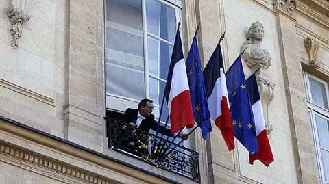 A hussard adjusts French and European Union's flags before an informal summit of European leaders to discuss the situation in Ukraine and European security at The Elysee Presidential Palace in Paris on 17 February 2025. European leaders were due to meet in Paris on 17 February 2025 to address Washington's shock policy shift on the war in Ukraine, as Britain declared itself ready to dispatch peacekeeping troops to Ukraine.