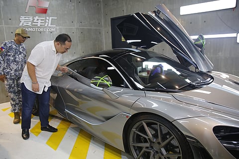 Customs Intelligence and Investigation Service-Manila International Container Port Manila Field Station chief Alvin Enciso inspects the seized luxury vehicles suspected to be smuggled into the country without payment of duties and taxes on imported goods in Makati City on Monday. At least 18 luxury vehicles were seized, including a Ferrari 812 Superfast, a Ferrari 488, a McLaren 720S, a Mercedes Benz G63 AMG and a Bentley Bentayga.