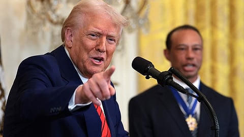 U.S. President Donald Trump, joined by golf legend Tiger Woods, speaks during a reception honoring Black History Month in the East Room of the White House on 20 February 2025 in Washington, DC.