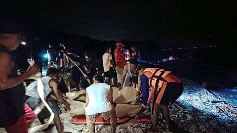 Rescuers put inside a body bag the bodies of two Russians who perished in a scuba diving venture in Verde Island, Batangas on Thursday.