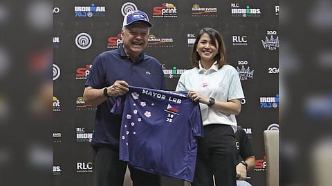 Puerto Princesa Mayor Lucilo Bayron (left) receives the IRONMAN 70.3 Puerto Princesa finisher’s shirt from LGR Sportswear COO Eunice Galura during the press launch of the third IRONMAN 70.3 Puerto Princesa that is on Sunday.