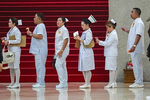 NEWLY registered nurses line up to enter their oath-taking ceremony last December at the Plenary Hall of the Philippine International Convention Center, CCP Complex, Roxas Boulevard, Pasay City. The Department of Migrant Workers has announced that it is now accepting applications from nurses and care workers interested in working in Japan under the Japan-Philippines Economic Partnership Agreement.