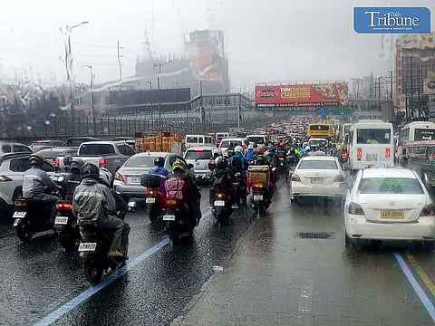 LOOK: Motorists drive through heavy downpours along the westbound lane of Commonwealth Avenue in Quezon City on Tuesday morning, 1 October 2024.